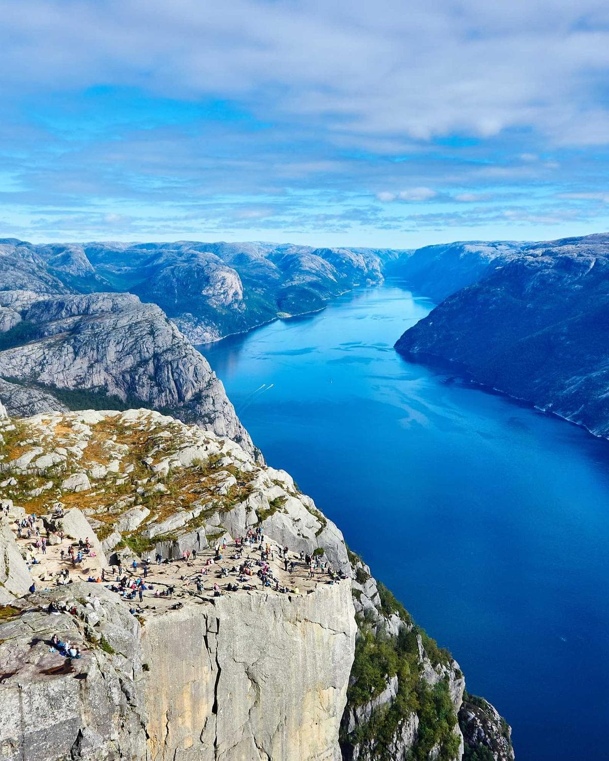 A deep blue fjord between steep rock walls