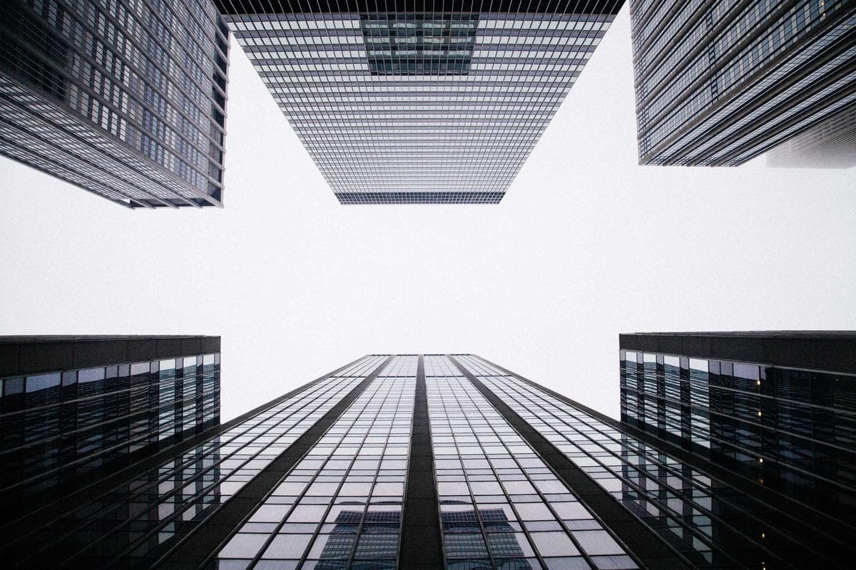 Glass towers seen from street level, looking up