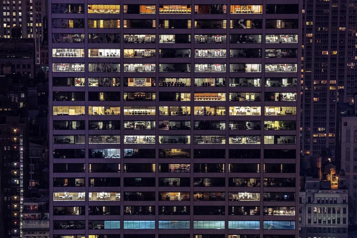 Office tower windows lit at night
